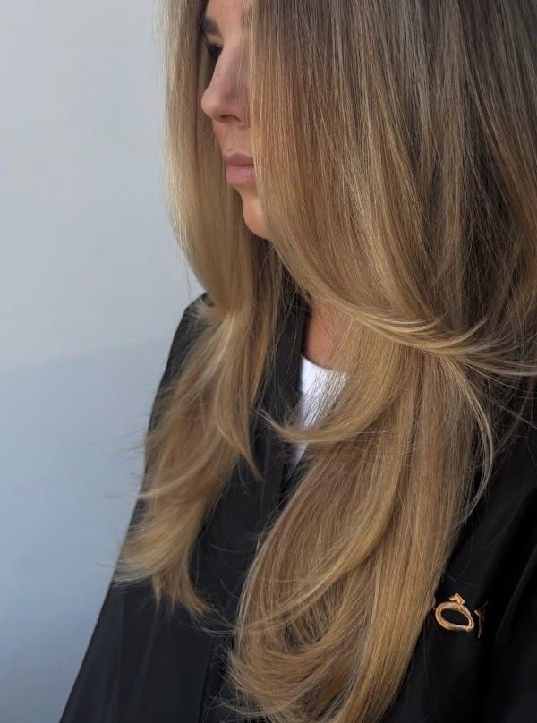 Golden blonde long layers at Ra'pôr Salon in Costa Mesa